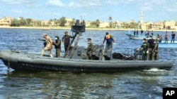 Egyptian coast guard and rescue workers bring ashore bodies recovered from a Europe-bound boat that capsized off Egypt's Mediterranean coast last week, in Rosetta, Egypt, Sept. 27, 2016.