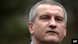 Crimean Premier Sergei Aksyonov attends the swearing in ceremony for the first unit of a pro-Russian armed force, dubbed the "military forces of the autonomous republic of Crimea" in Simferopol, Ukraine, March 8, 2014.