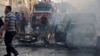 Syrians gather at the site of an explosion in the northeastern Kurdish city of Qamishli, Oct. 11, 2019. 