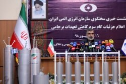 FILE - Atomic Energy Organization of Iran spokesman Behrouz Kamalvandi speaks during a news briefing with advanced centrifuges displayed in front of him, in Tehran, Sept. 7, 2019.