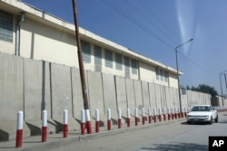 FILE - A car passes American University of Afghanistan in Kabul, Afghanistan, Aug. 8, 2016.