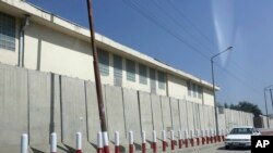 FILE - A car passes American University of Afghanistan in Kabul, Afghanistan, Aug. 8, 2016.