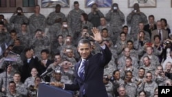 President Barack Obama waves to U.S. service members after being introduced at a Veteran's Day event at U.S. Army Garrison Yongsan in Seoul, South Korea, 11 Nov 2010