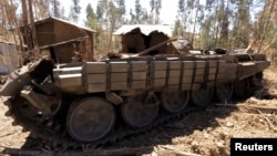 A tank destroyed recently during fighting between the Ethiopian National Defense Force (ENDF) and the Tigray People's Liberation Front (TPLF) forces is seen on the roadside in Gashena of Amhara region, Ethiopia Dec. 7, 2021.