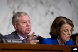Senate Judiciary Committee Chairman Lindsey Graham, accompanied by Ranking Member Sen. Dianne Feinstein, D-Calif.,(R) questions Attorney General nominee William Barr during a Senate Judiciary Committee hearing on Capitol Hill, Jan. 15, 2019.