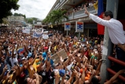 FILE - Venezuelan opposition leader Juan Guaido, who many nations have recognized as the country's rightful interim ruler, greets supporters during a gathering in Charallave, Venezuela, June 8, 2019.