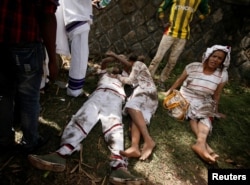 FILE - Injured protesters wait for help after several people died during the Irrechaa, the thanksgiving festival of the Oromo people in Bishoftu town of Oromia region, Ethiopia, Oct. 2, 2016.