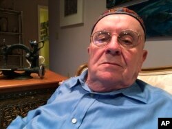 In this Monday, Oct. 29, 2018 photo, Holocaust survivor Judah Samet, 80, sits in his living room in Pittsburgh.
