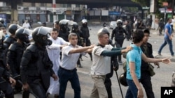 Supporters of ousted President Mohamed Morsi are detained during clashes with riot police in Cairo, Egypt, Sunday, Oct. 6, 2013.