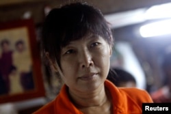 Than Dar, the wife of slain journalist Par Gyi, is seen during a Reuters interview at her home, in Yangon, Myanmar, Oct. 28, 2014.