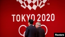 IOC President Thomas Bach walks with Japan's Prime Minister Shinzo Abe during the 'One Year to Go' ceremony celebrating one year out from the start of the summer games at Tokyo International Forum in Tokyo, Japan July 24, 2019.