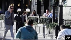 People sit in an outdoor restaurant area in Christchurch, New Zealand, June 8, 2020. 