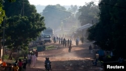 FILE - People walk on a main street in Bambari, Central African Republic, May 25, 2014. 