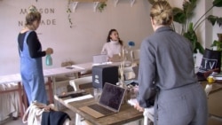 Staff at Maison Nomade restaurant prepare for its reopening next Wednesday. The EU has notched up the region's growth predictions for this year. (Lisa Bryant/VOA)