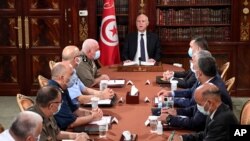 Tunisia's President Kais Saied, center, leads a security meeting with members of the army and police forces in Tunis, July 25, 2021. 