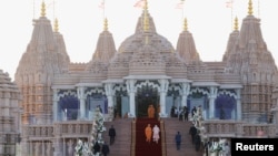 Indian Prime Minister Narendra Modi climbs the stairs as he attends the inauguration of the BAPS Hindu temple in Abu Dhabi, United Arab Emirates, on Feb. 14, 2024.
