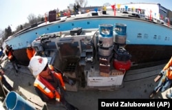 SAM, a semi-automated mason, is shown at work on a school in Englewood, Colorado.