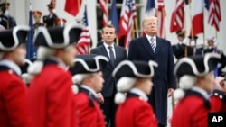 President Donald Trump and French President Emmanuel Macron stand during a State Arrival Ceremony on the South Lawn of the White House in Washington, April 24, 2018.