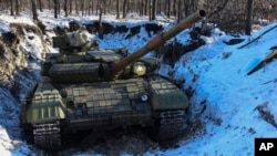 A pro-Russia separatists' tank is seen in a fortified position at a check-point north of Luhansk, eastern Ukraine, Jan. 14, 2015.