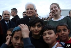 Italian President Sergio Mattarella visits the Elaionas refugee camp, where 2,000 people live in Athens, Jan. 17, 2017. Mattarella is on a two-day official visit in Greece.