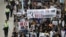 Demonstrators march during a protest over the disappearance of booksellers in Hong Kong, Jan. 10, 2016. The banner reads, in part: "Against political kidnapping. ... Demanding the immediate release of the five people from Causeway Bay Books."