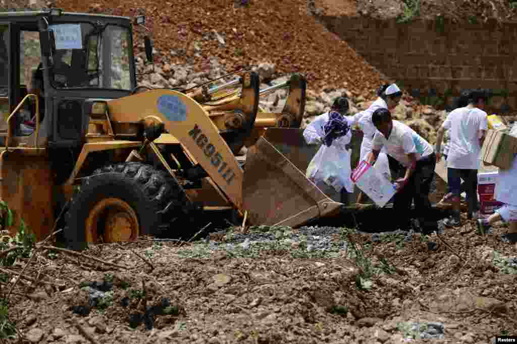 A front loader carrying medicines arrives at a quake zone at Longtoushan, Dudian county, in Zhaotong, Yunnan province, Aug. 5, 2014.