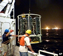 Sampling device being lowered from the Endeavor research vessel.