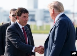 President Donald Trump is greeted by 12th Congressional District Republican candidate Troy Balderson as he arrives on Air Force One at John Glenn Columbus International Airport in Columbus, Ohio, Aug. 4, 2018.