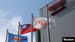 Flags of Taiwan and Taiwan Semiconductor Manufacturing Co (TSMC) are displayed next to its headquarters in Hsinchu, Taiwan October 5, 2017. (REUTERS/Eason Lam)