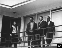 The Rev. Martin Luther King Jr., second from right, stands with other civil rights leaders, including the Rev. Jesse Jackson Sr., second from left, on the balcony of the Lorraine Motel in Memphis, Tennessee, a day before King was assassinated, April 3, 1968.