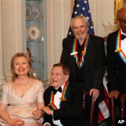 Secretary of State Hillary Clinton, left, talks with Kennedy Center honorees, Jerry Herman, Merle Haggard, Bill T. Jones and Paul McCartney while waiting for Oprah Whitney to arrive