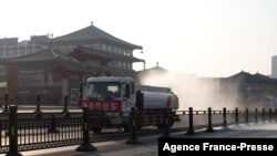 A truck sprays disinfectant on street in Xi'an in China's northern Shaanxi province, Dec. 31, 2021, amid a Covid-19 lockdown.