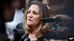 FILE - Canadian Foreign Affairs Minister Chrystia Freeland speaks to reporters as she arrives at the Office of the U.S. Trade Representative, Sept. 11, 2018, in Washington. 