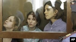 Members of punk group Pussy Riot on trial in glass-enclosed courtroom cage, Moscow, July 30, 2012.