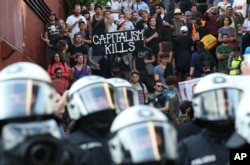 Police officers confront a protest against the upcoming G-20 summit in Hamburg, Germany, July 6, 2017.