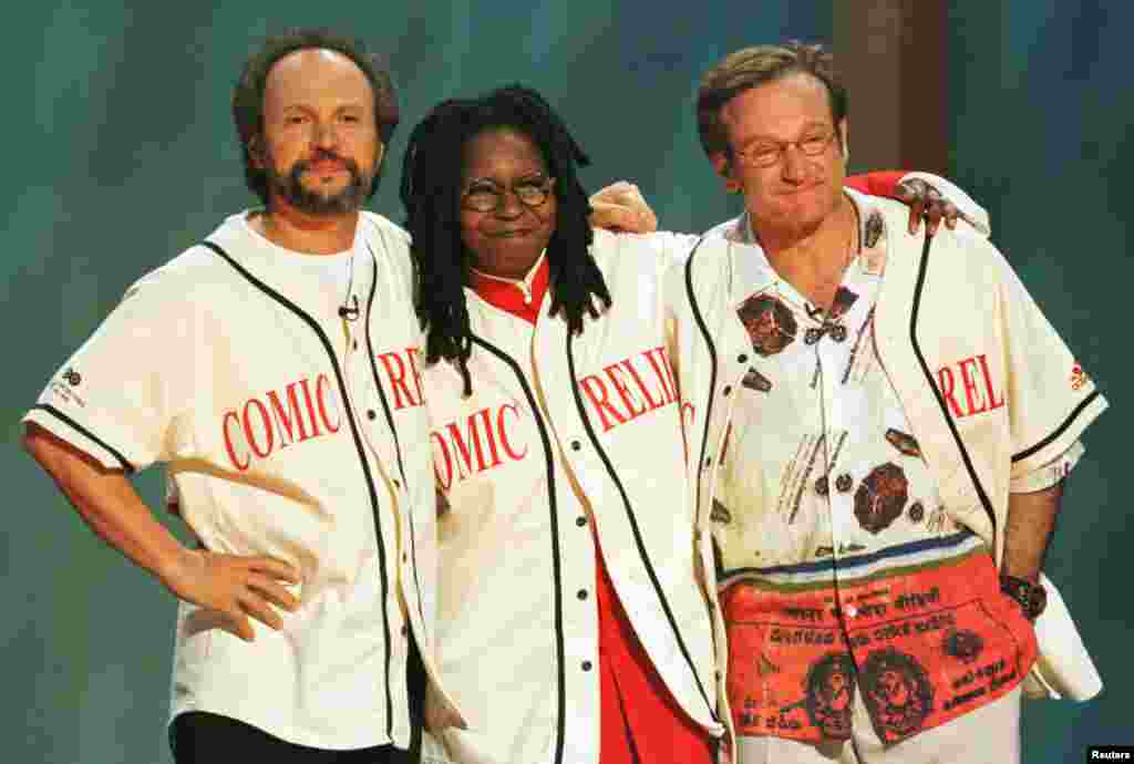 Comedians Robin Williams (R), Billy Crystal (L) and Whoopi Goldberg share a hug on the stage of New York's Radio City Music Hall at the end of HBO's "Comic Relief 8" show, June 14, 1998. The comedians served as hosts for the show that raises funds for homeless projects in over 20 American cities.