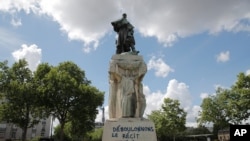 Graffiti reading "down with the official version" is seen on the base of the statue of French military commander Joseph Gallieni, outside the Invalides monument, June 16, 2020 in Paris.
