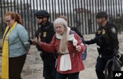 Women are detained during a protest in San Diego, near the border with Tijuana, Mexico, Dec. 10, 2018.
