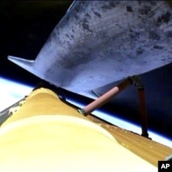 The space shuttle Atlantis releases its fuel tank for the final time, July 8, 2011