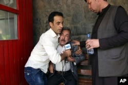 A man cries at a hospital after he lost his journalist son in explosions in Kabul, Afghanistan, April 30, 2018.