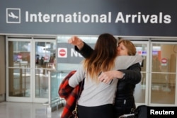 FILE - Mahnaz Kanani Zadeh, right, is greeted by her niece Negin after traveling to the U.S. from Iran following a federal court's temporary stay of U.S. President Donald Trump's executive order travel ban, at Logan Airport in Boston, Massachusetts, Feb. 6, 2017.