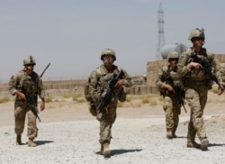 FILE - U.S. troops patrol at an Afghan National Army base in Logar province, Afghanistan, Aug. 7, 2018.