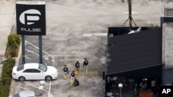 FBI officials leave the Pulse night club, the site of a mass shooting days earlier, in Orlando, Florida, June 15, 2016.