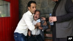 A man cries at a hospital after he lost his Journalist son in explosions in Kabul, Afghanistan, Monday, April 30, 2018.