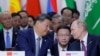 Russian President Vladimir Putin, right, and Chinese President Xi Jinping speak during a plenary session in the outreach/BRICS Plus format at the BRICS summit in Kazan, Russia, Oct. 24, 2024.
