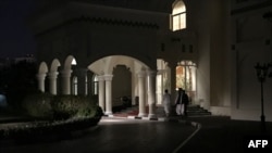 FILE - Members of Taliban negotiating team enter the venue housing the talks between U.S. and Taliban negotiators in the Qatari capital Doha, Aug. 29, 2019. 