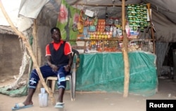 A South Sudanese vendor waits for customers at his makeshift shop in the SPLA-IO rebel control area in the Southern part of Unity State Paynjiar County, March 20, 2015.