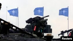 NATO flags flutter during the final day of NATO Saber Strike exercises in Orzysz, Poland, June 16, 2017. 