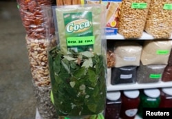 FILE - Coca leaves for sale and other products are display in a market in Surquillo Lima's district, Feb. 25, 2015.