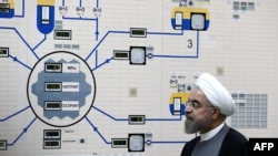 FILE - A handout picture released by the official website of the Iranian President Hassan Rouhani shows him visiting the control room of the Bushehr nuclear power plant in the Gulf port city of Bushehr, Jan. 13, 2015. 